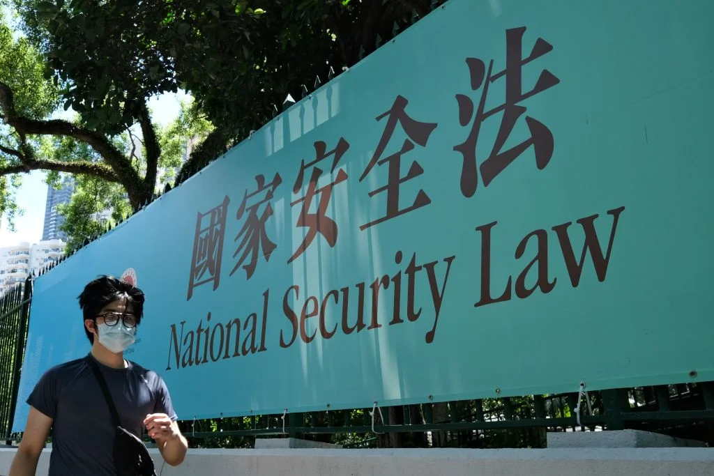 A man walks past a public notice banner for the National Security Law in Hong Kong on July 15, 2020. ANTHONY WALLACE—AFP/Getty Images